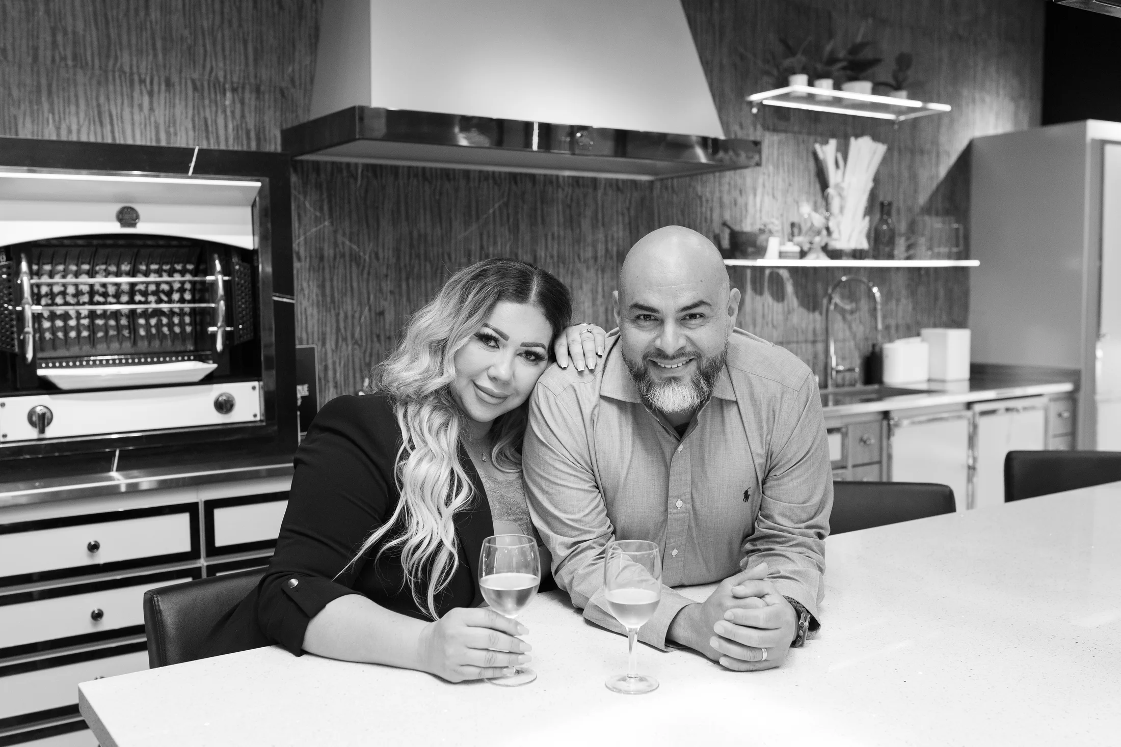 Rocio and Jorge Vasquez, owners of CASA Renovations, at the showroom kitchen island