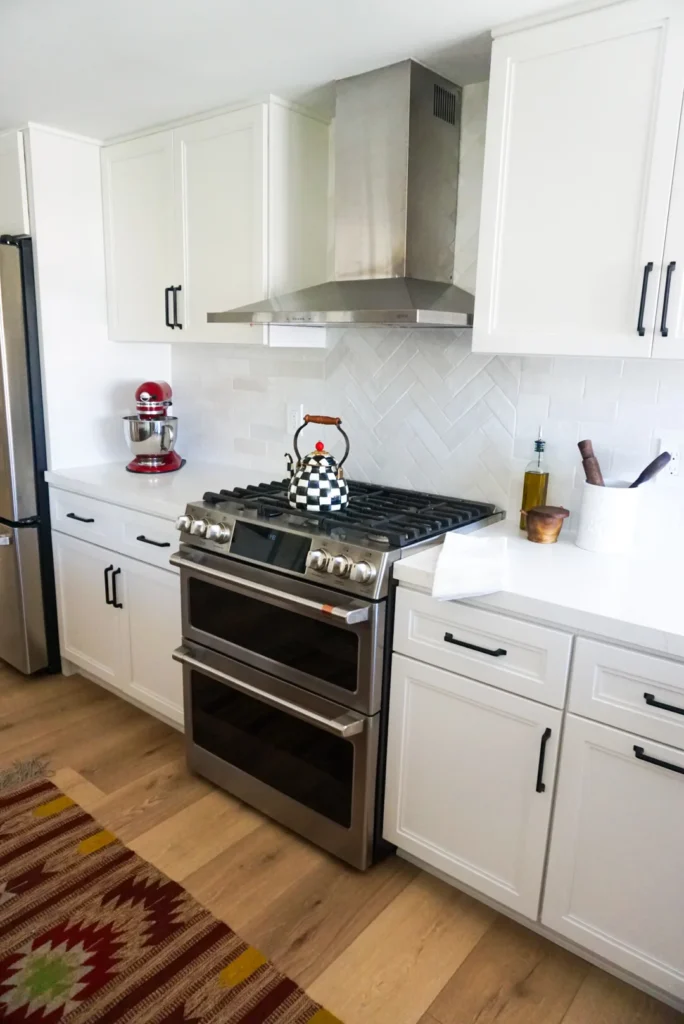 Range and hood with tile backsplash, Alessandro Heights remodel by CASA Renovations
