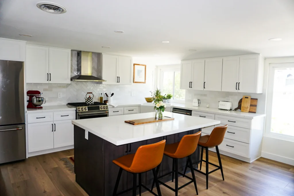 Kitchen island with dark base and stools, Alessandro Heights remodel