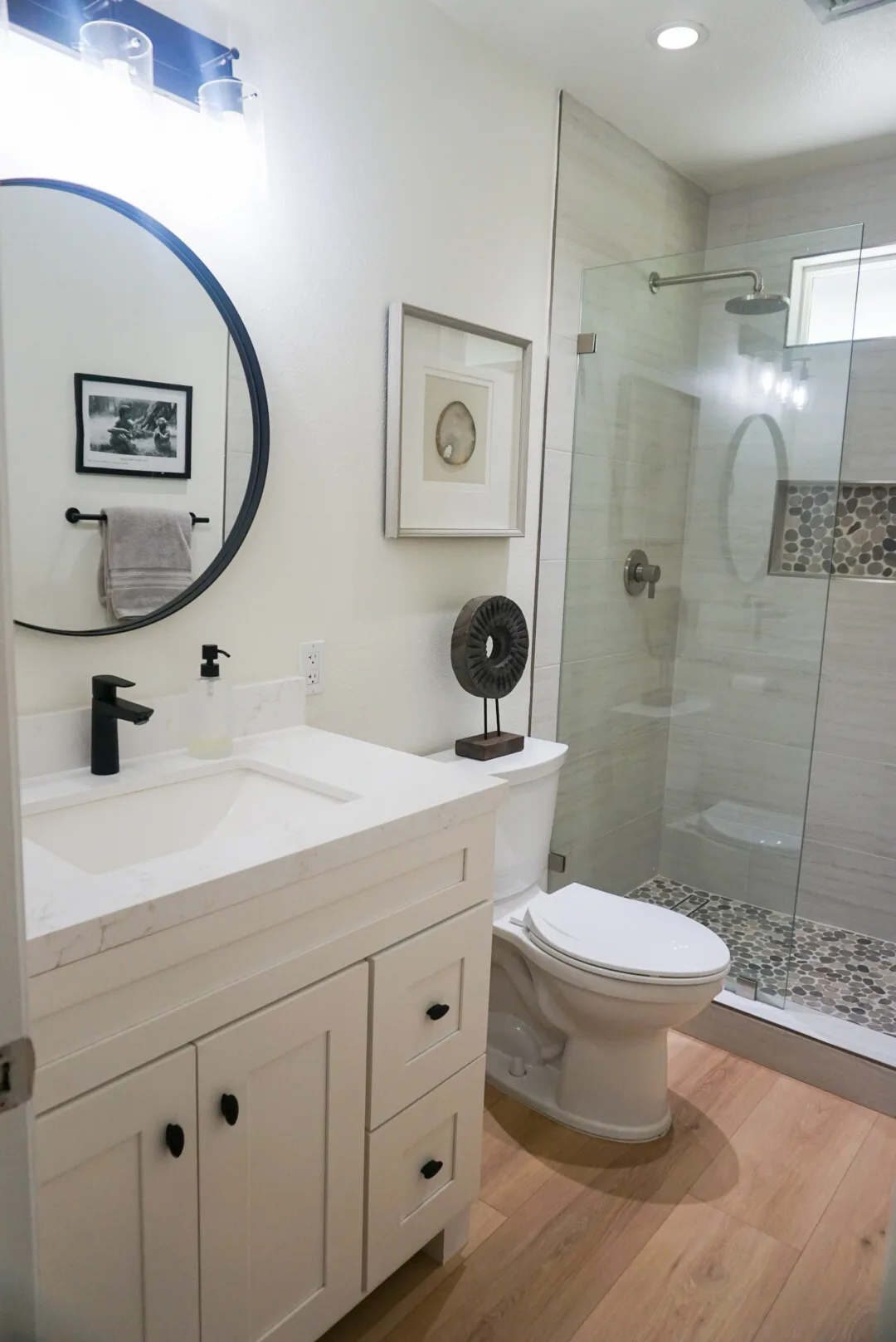 Bathroom with round mirror and walk-in shower, Alessandro Heights remodel