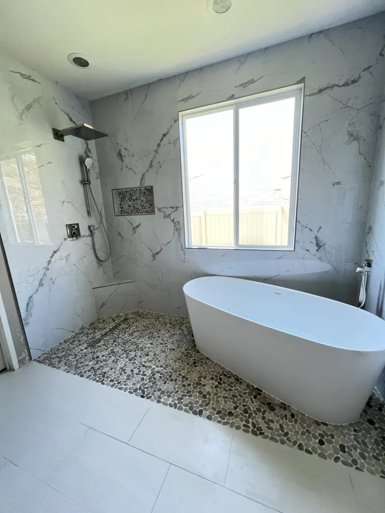 Freestanding tub under a window beside the walk-in shower, Corona Hills