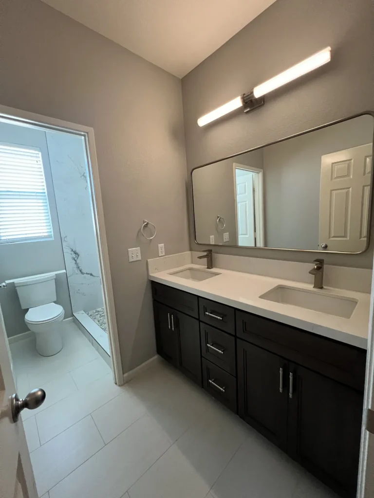 Double vanity with light bars, looking toward the water closet, Corona Hills