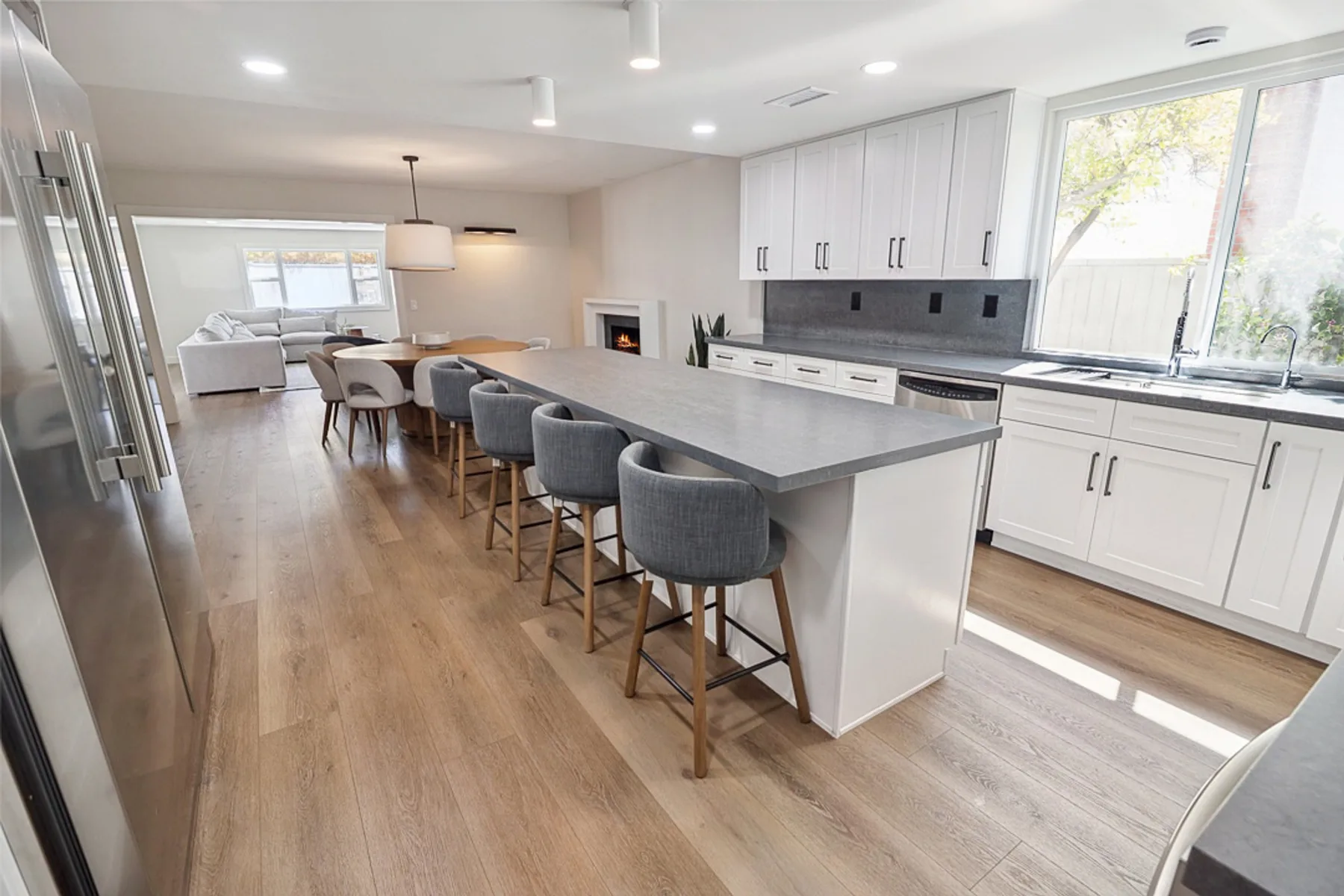 Open kitchen and dining with island seating, a CASA Renovations remodel in La Jolla