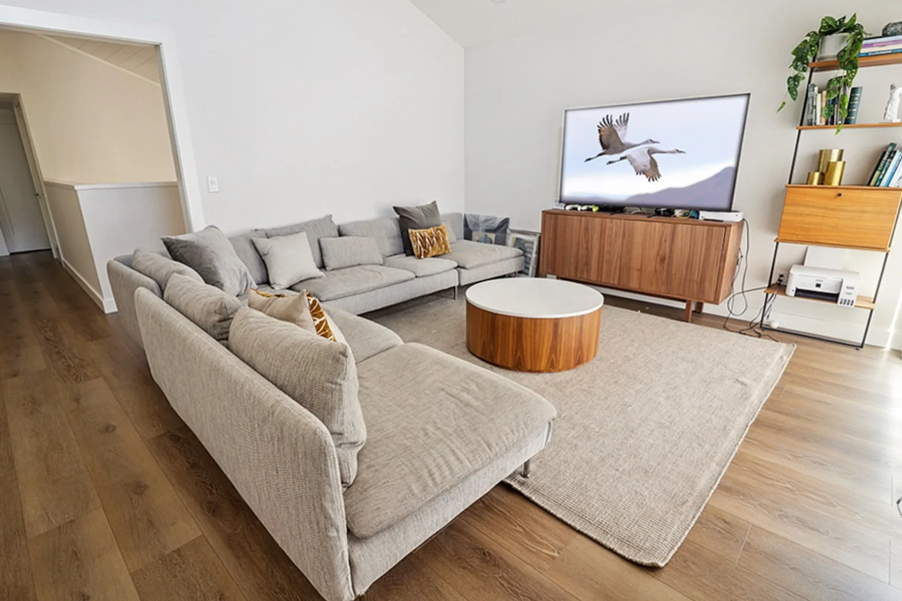 Family room with sectional and round coffee table, La Jolla remodel