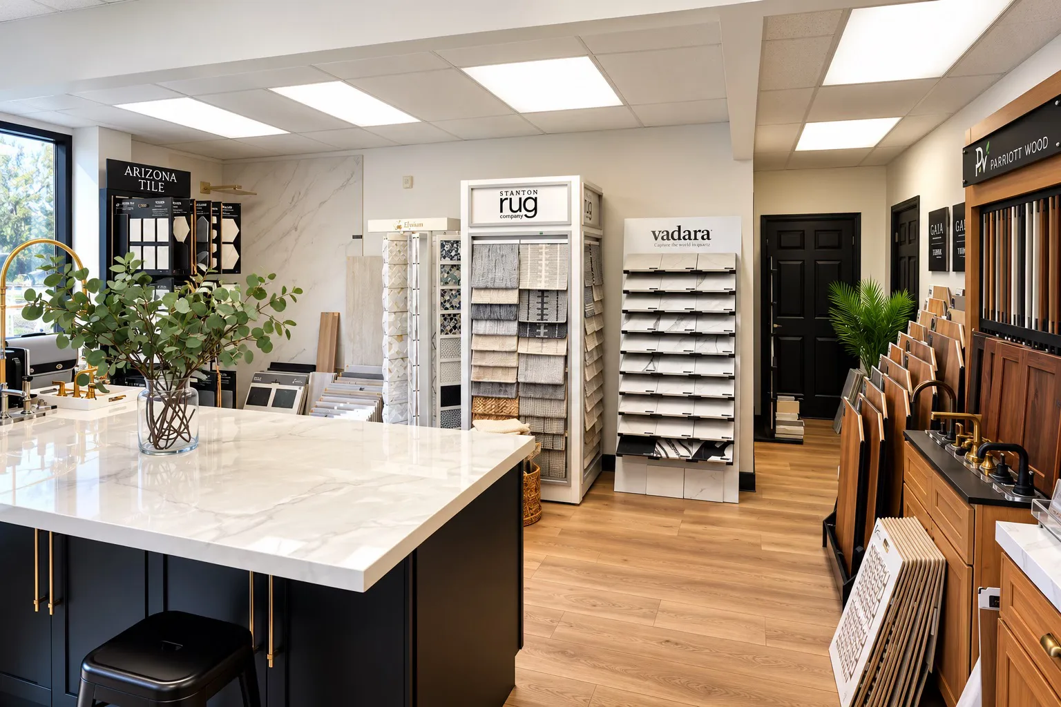 The CASA Renovations showroom in Riverside, with a marble sample island, rug displays and flooring racks