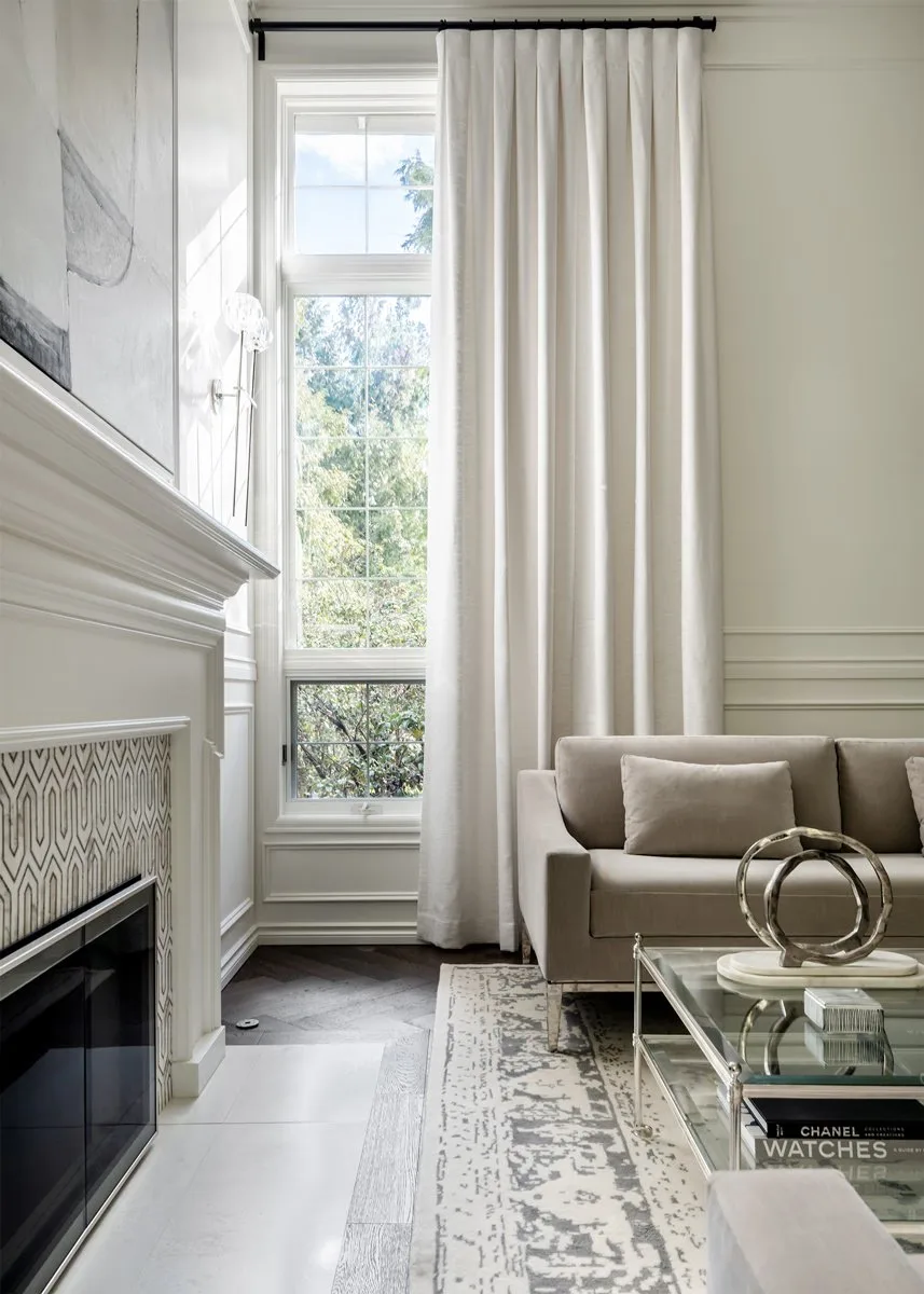 Floor-length custom drapery on a tall living room window