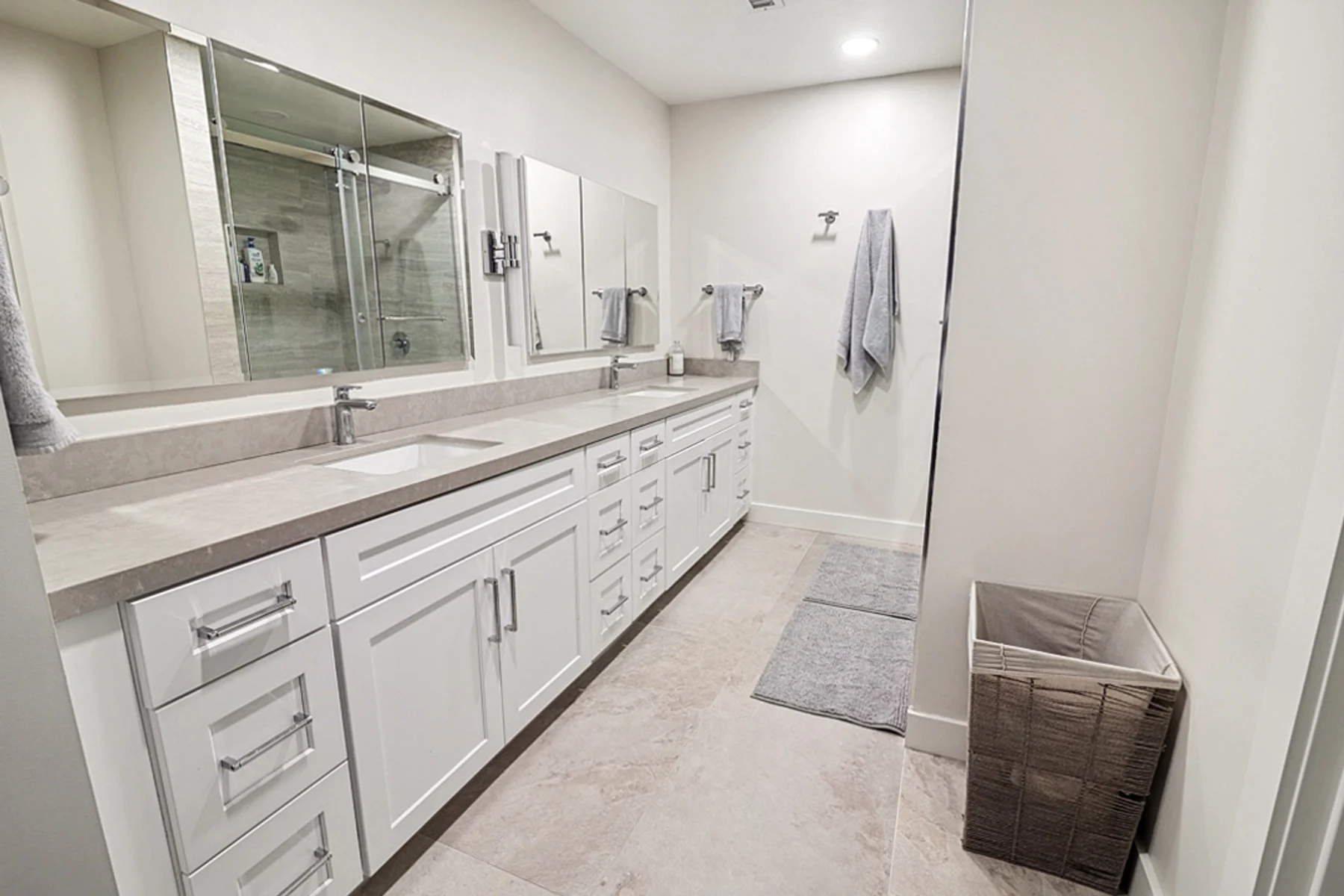 Primary bathroom with a double vanity and framed mirrors